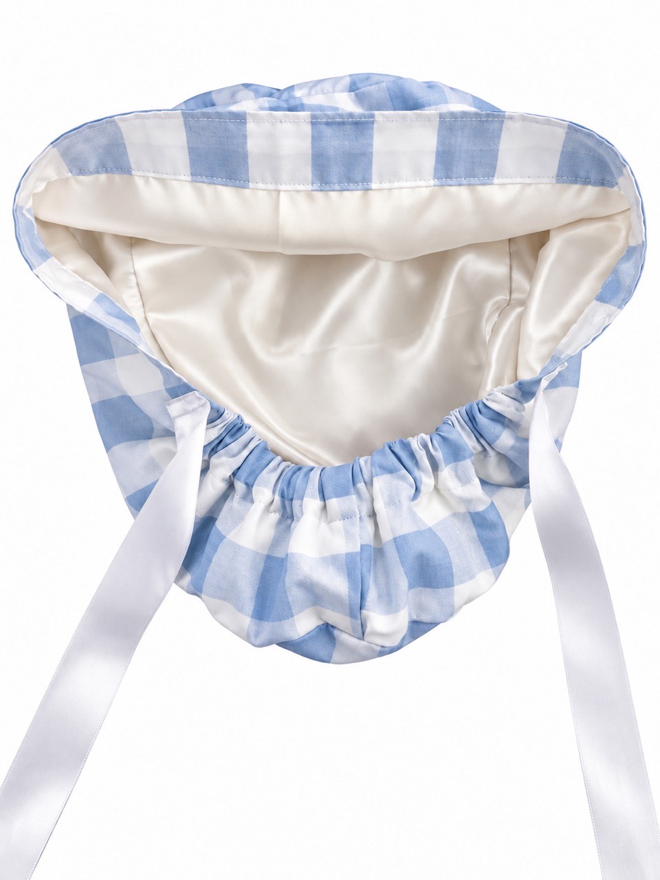 Inside the women’s gingham scrub cap, showing its light-colored lining and white ribbon ties
