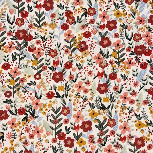Small red, coral, and yellow flowers with dark green foliage on ivory.