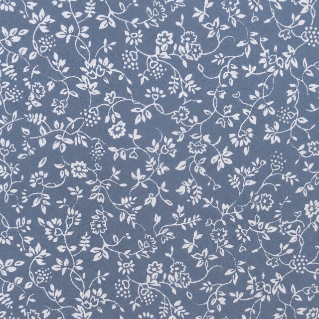 White trailing floral vines on dusty blue.
