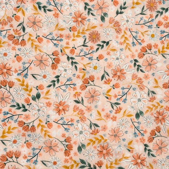 Peach and white flowers with green leaves and tiny blue blossoms.